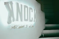 a white sign with the word knock on it