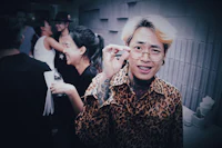a man wearing a leopard print shirt and glasses